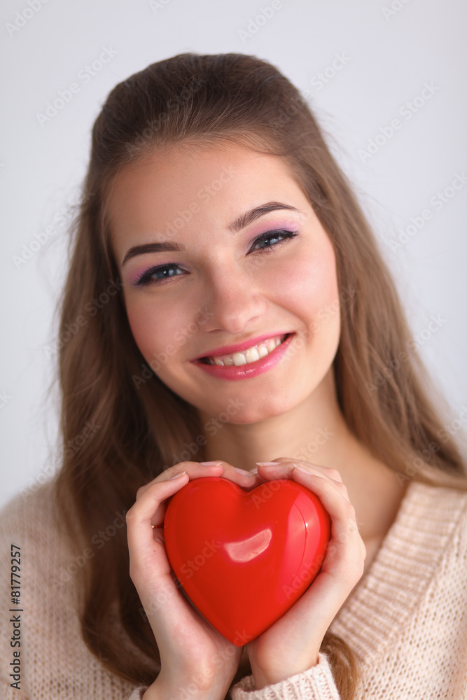 Portrait of beautiful happy woman holding a symbol heart. Portrait of beautiful happy woman holding a symbol heart.