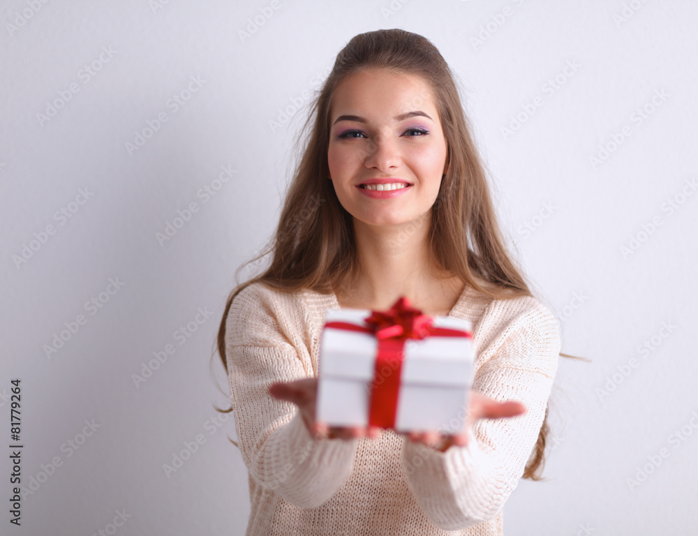 Young woman happy smile hold gift box in hands,standing over Young woman happy smile hold gift box in hands,standing over