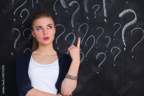 Young girl with question mark on a gray background