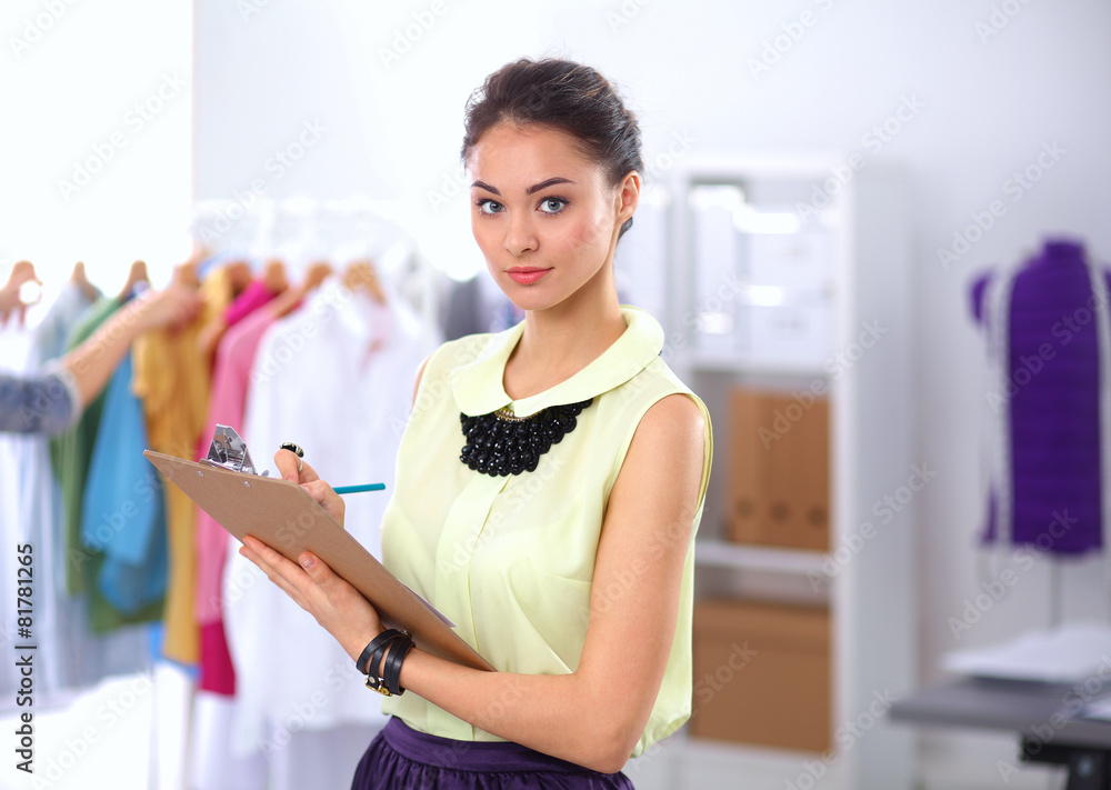 Modern young fashion designer working at studio. Modern young fashion designer working at studio.