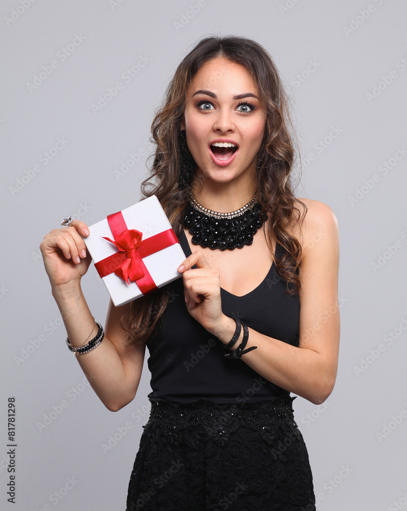 Fototapeta premium Young woman happy smile hold gift box in hands, isolated over