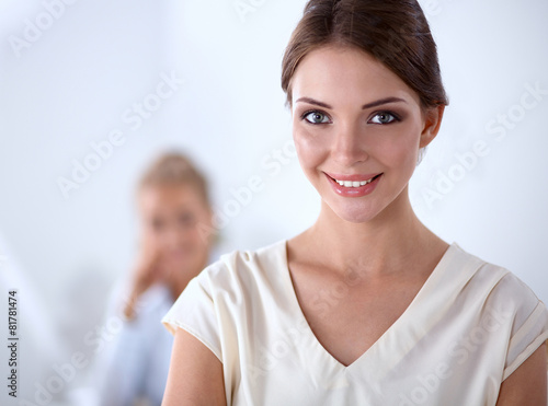 Attractive businesswoman with her arms crossed standing in