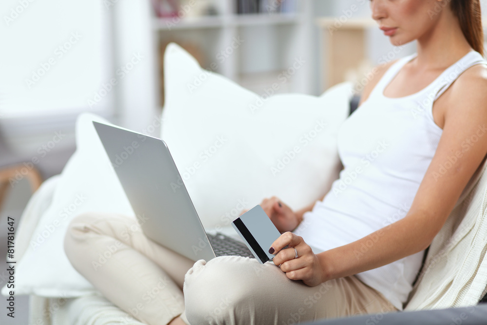 Woman shopping online with credit card and computer. Woman shopping online with credit card and computer.