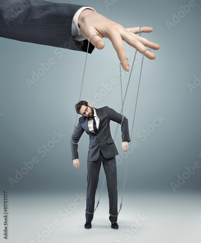 Photography conceptual picture of a boss pulling the strings
