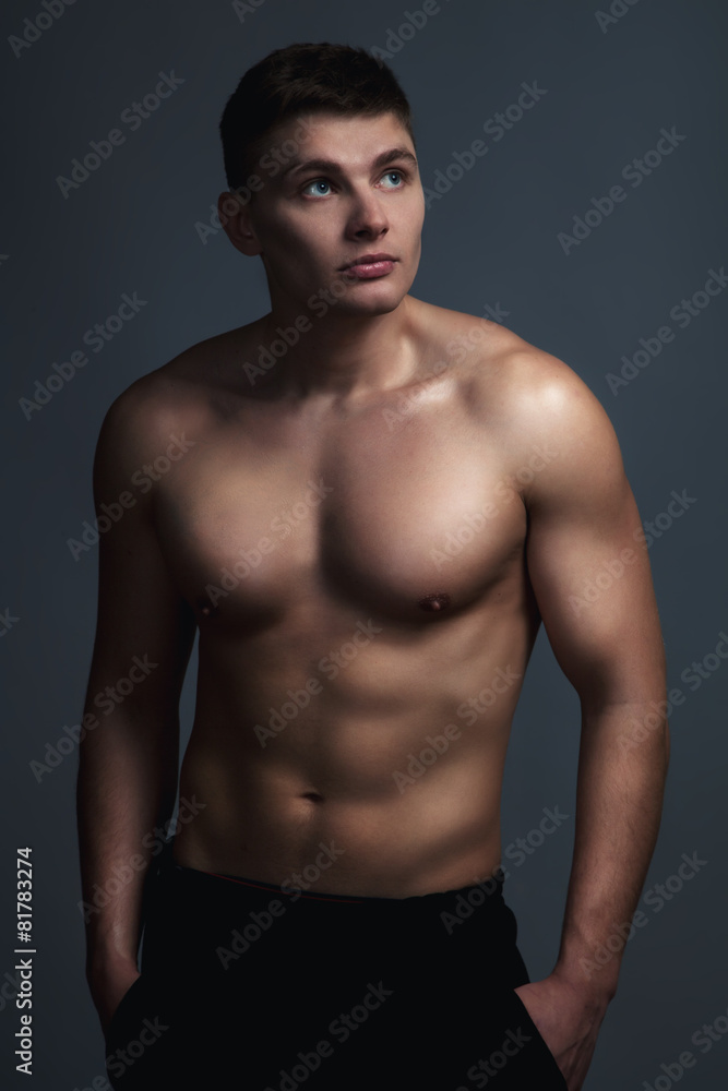 Sexy athletic man over grey background.