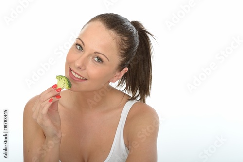 Attractive Young Woman Eating Raw Broccoli
