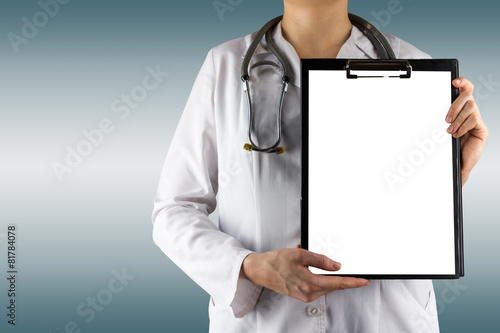 Female doctor's hand holding blank medical clipboard and stethos