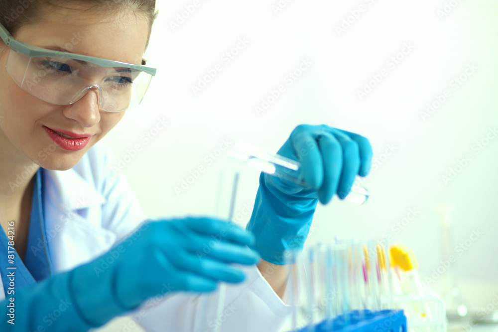 Woman researcher is surrounded by medical vials and flasks Woman researcher is surrounded by medical vials and flasks