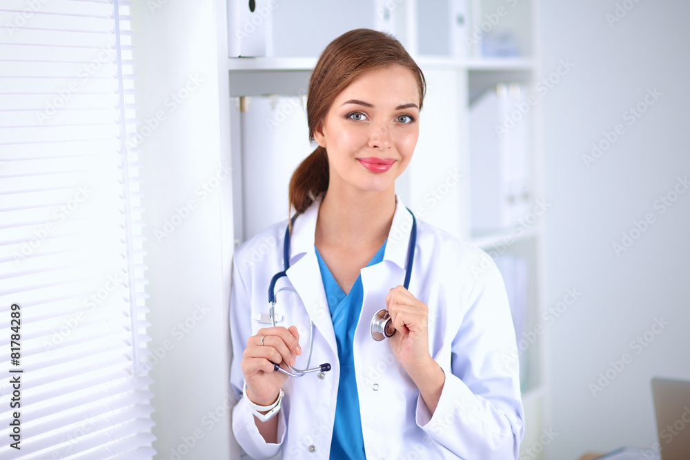 Woman doctor is standing near window Woman doctor is standing near window