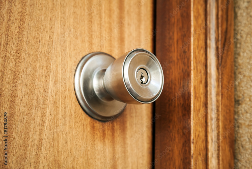Shining metal door handle with keyhole, closeup Shining metal door handle with keyhole, closeup