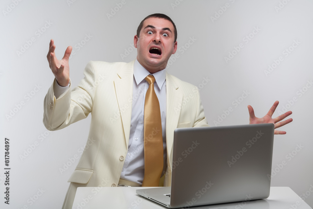 A man in a white suit sitting with a laptop. Makes hand gestures A man in a white suit sitting with a laptop. Makes hand gestures