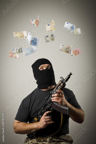 Man with gun and euro banknotes.