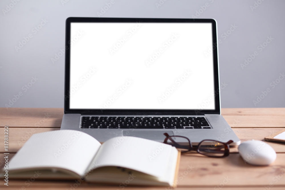 Laptop stands on a wooden table Laptop stands on a wooden table