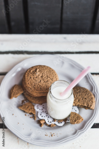 Rustic home made cookies on the wooden background with milk