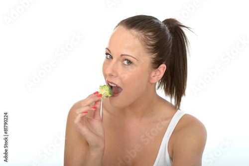 Attractive Young Woman Eating Raw Broccoli