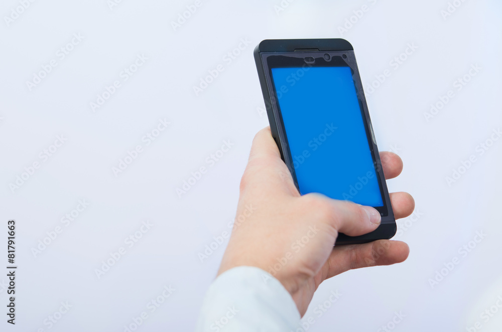 man's hand holding cell phone with empty blue screen man's hand holding cell phone with empty blue screen