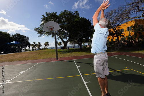 Stock image old man playing basketball