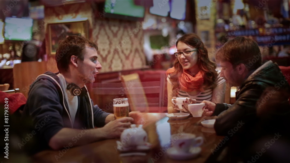 Group of young attractive cheerful friends meet in bar. Laughing Group of young attractive cheerful friends meet in bar. Laughing
