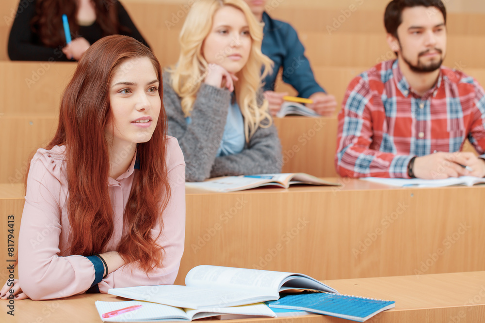 Female student smiles during lecture Female student smiles during lecture
