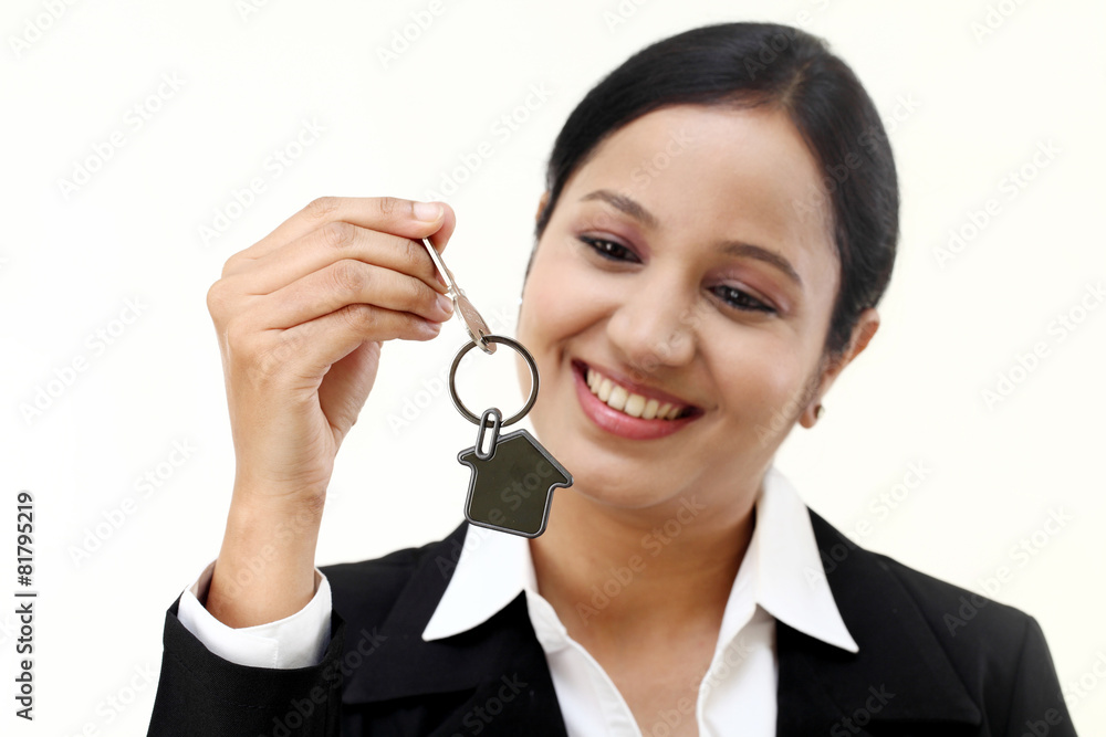 Business woman holding house key Business woman holding house key