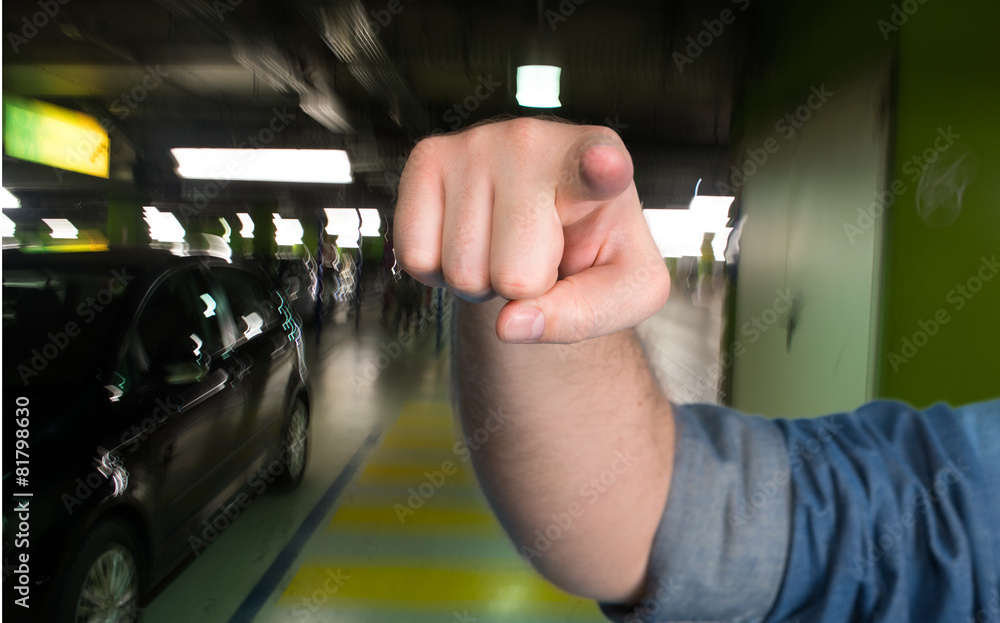 Fototapeta premium Man pointing in the parking garage