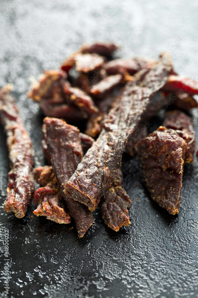 beef jerky on old black table beef jerky on old black table