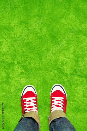 Feet From Above, Teenager in Sneakers Standing on Green Backgrou