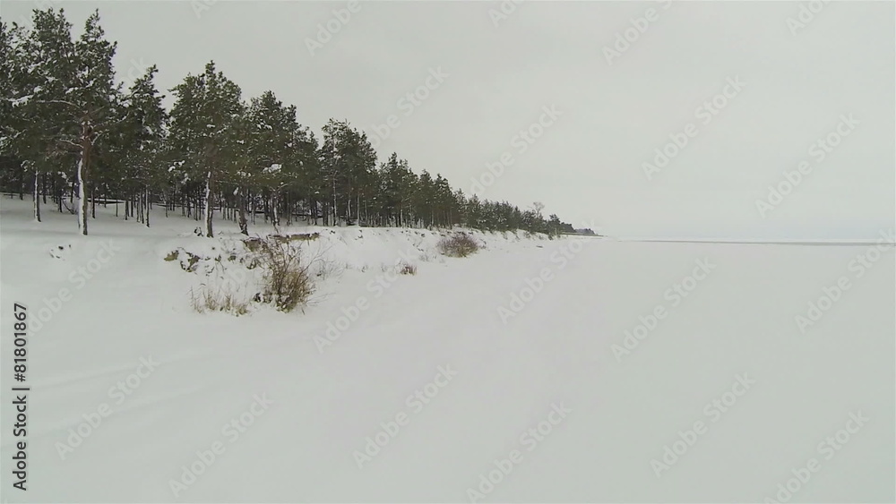 coast of frozen lake covered with snow. Aerial coast of frozen lake covered with snow. Aerial