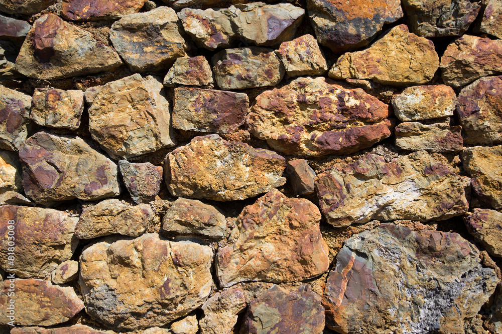 Old stone wall constructed from old copper mine stone Old stone wall constructed from old copper mine stone