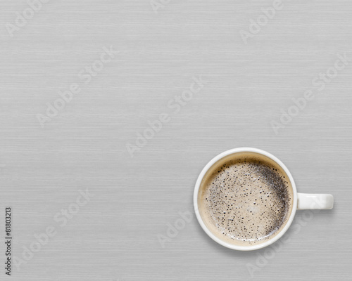 White cup of hot coffee on gray background.