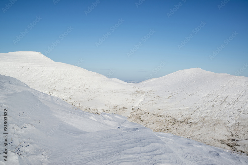 Stunning blue sky mountain landscape in Winter with snow covered
