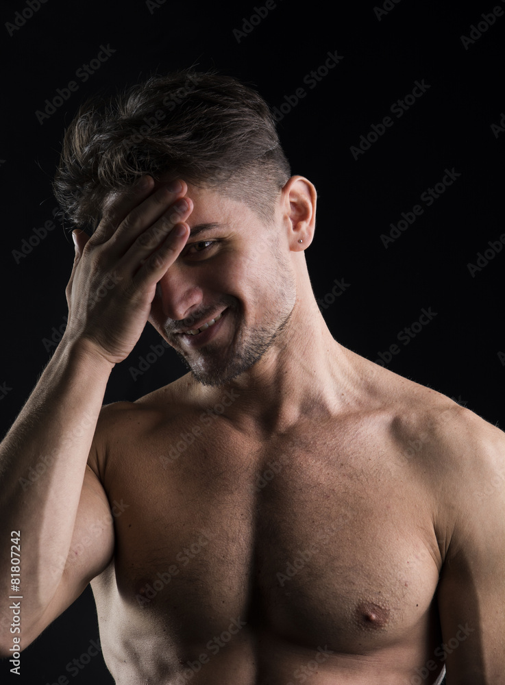 Muscular shirtless young man portrait isolated Muscular shirtless young man portrait isolated