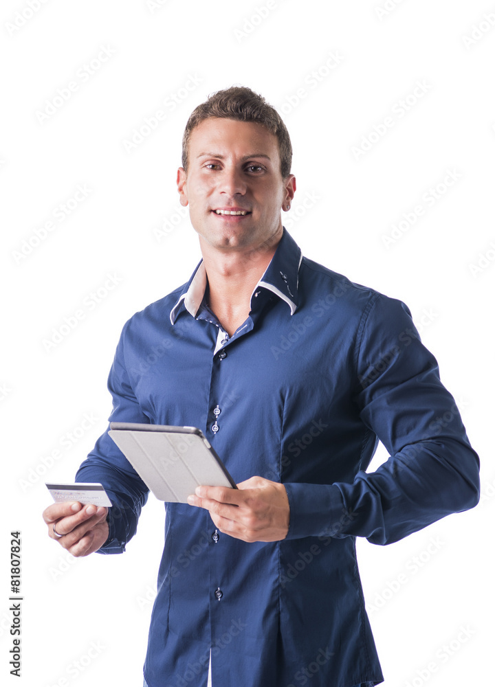 Young Businessman Holding a Credit Card and Tablet Computer Young Businessman Holding a Credit Card and Tablet Computer
