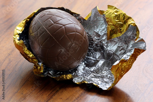 chocolate egg unwrapped in gold foil