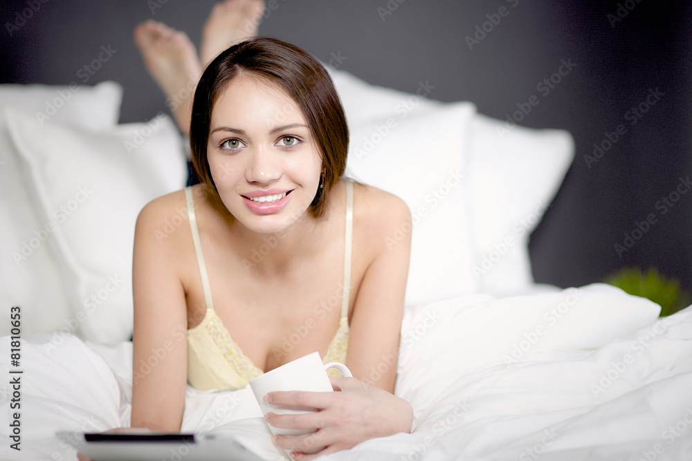 Women use a tablet pc on the bed Women use a tablet pc on the bed