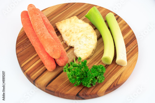 Mirepoix on wooden cutting board with white background