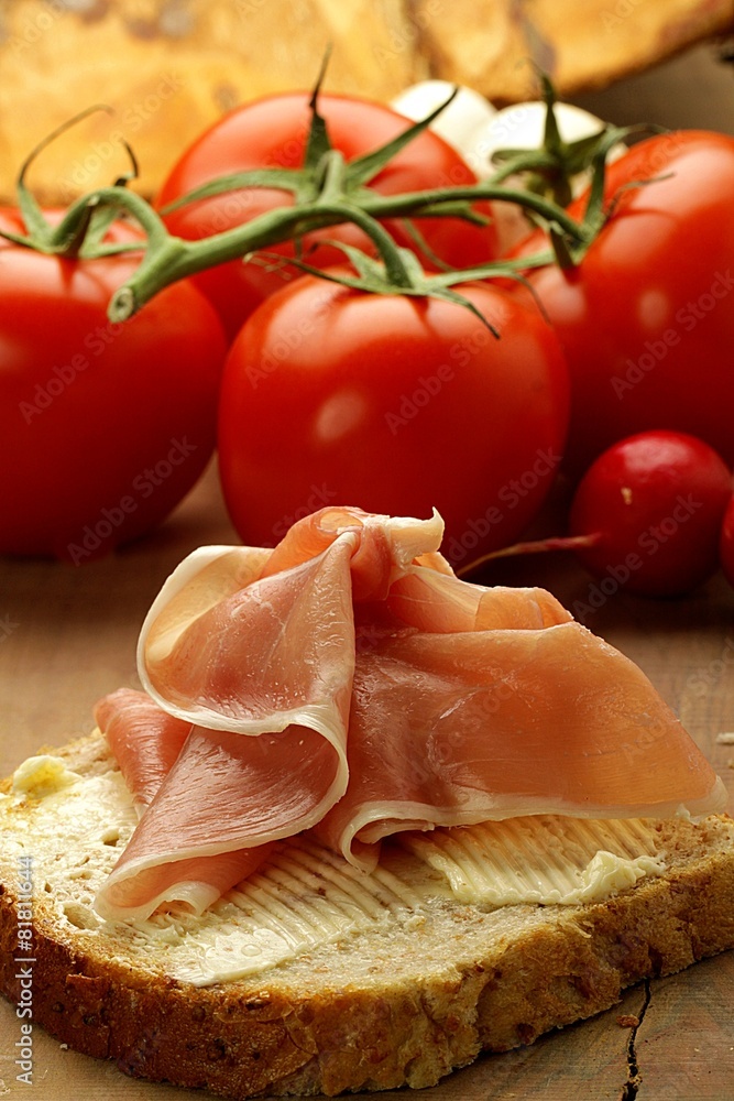 ham sandwich on a background with tomatoes