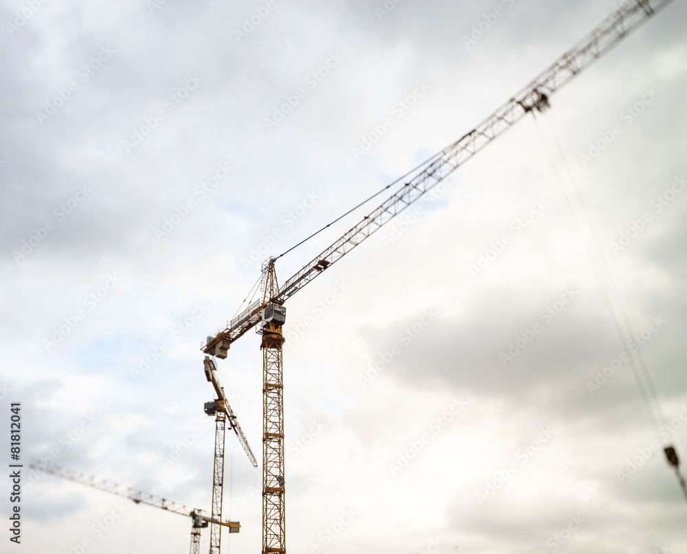 Crane and building construction site against the sky Crane and building construction site against the sky