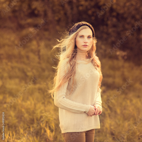 beautiful hipster girl in a cap in the park