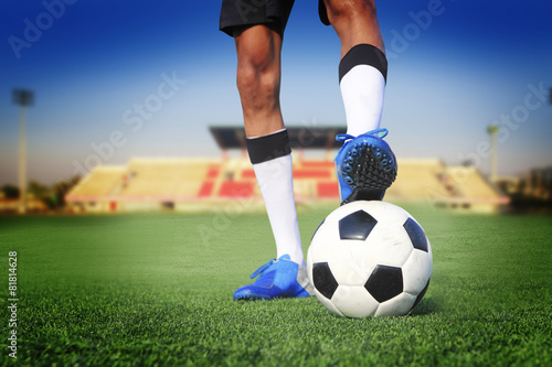 soccer ball with feet player on the football field