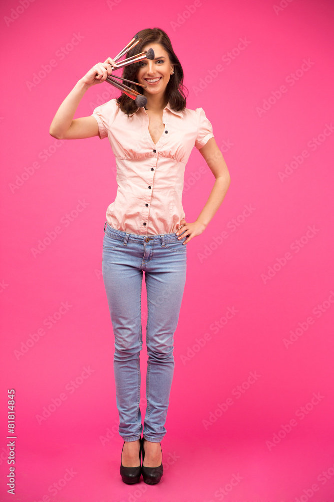Smiling woman holding brushes Smiling woman holding brushes