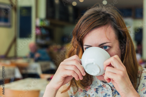 Woman drinking coffee in a cafe