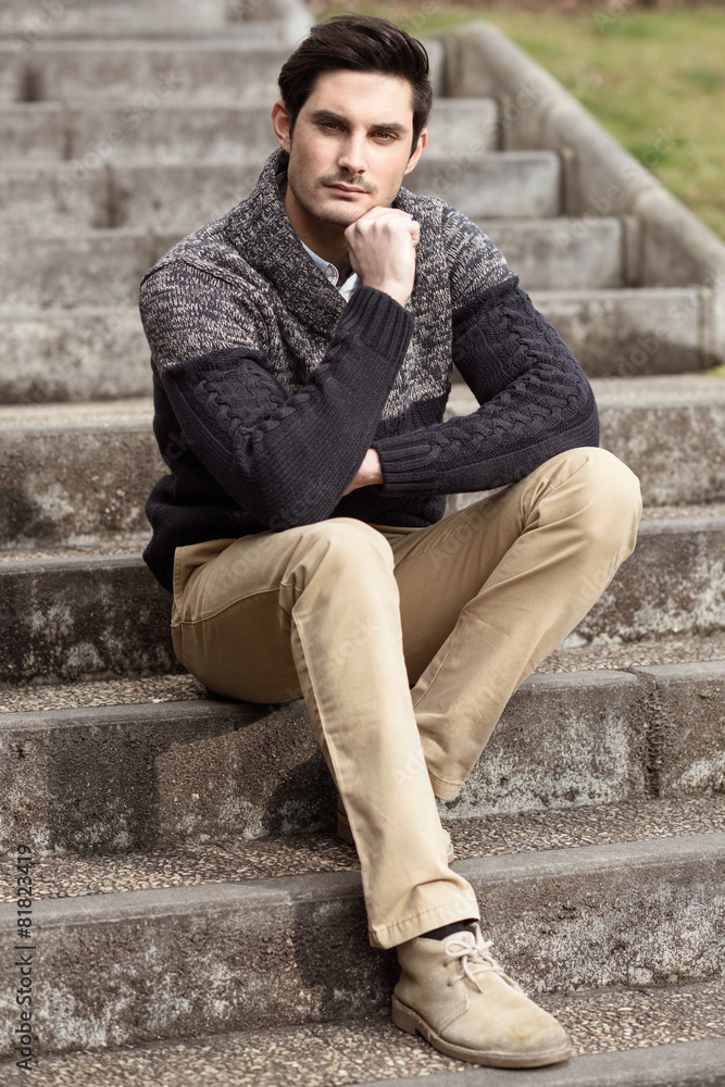 Attractive young handsome man, model of fashion in urban backgro Attractive young handsome man, model of fashion in urban backgro
