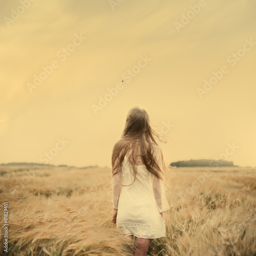 beautiful girl walks into the field
