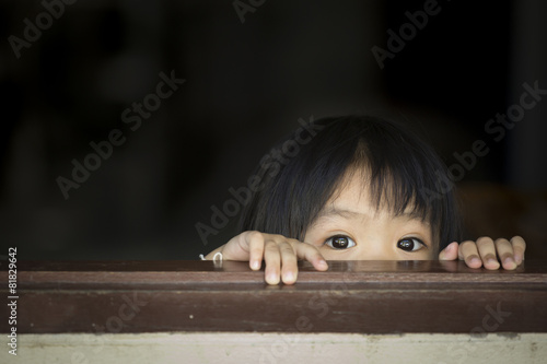 Asian baby behind the windows photo