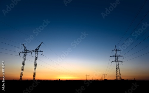 Large transmission towers at blue hour