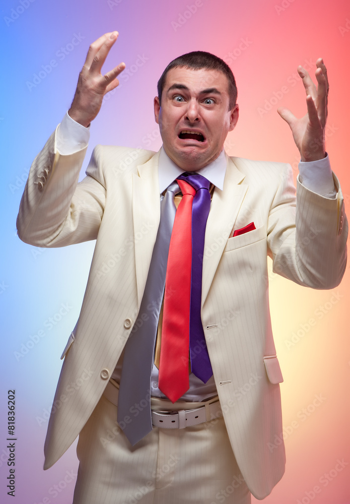 Man in white suit with three colored ties. Vivid emotions. Crazy Man in white suit with three colored ties. Vivid emotions. Crazy