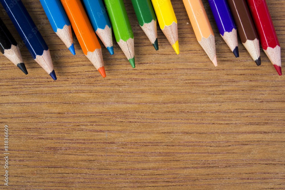 Obraz premium pencils color on wood background, top view
