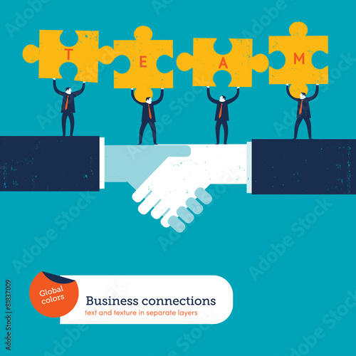 Businessmen with puzzle pieces with the word team
