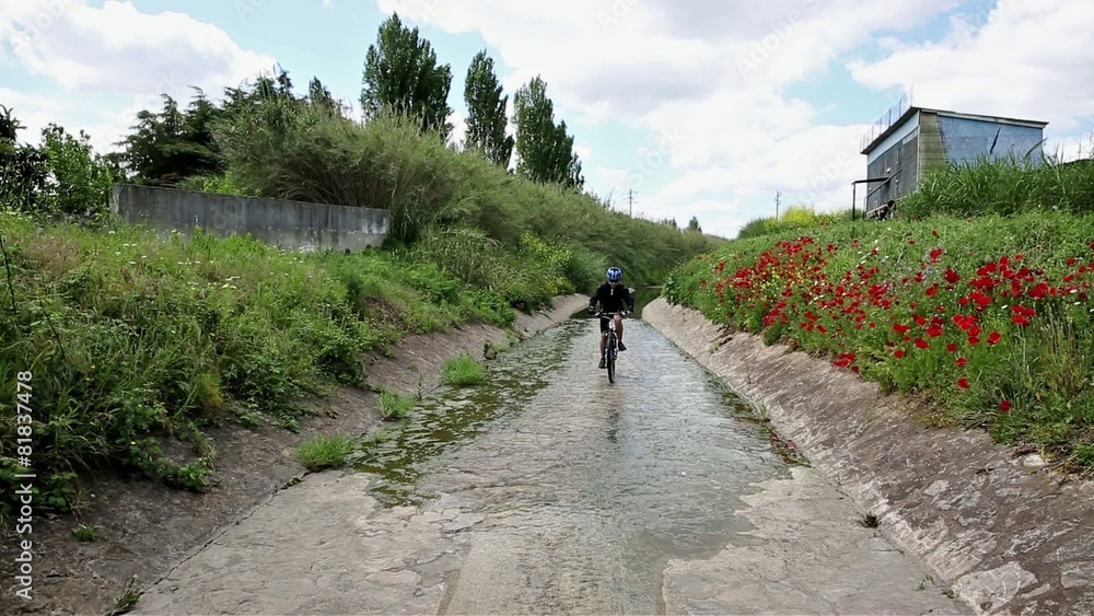mountain bicycle riding in a brook in the countryside